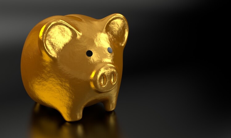 a gold piggy bank on a black background